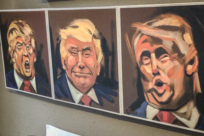 Horizontal painting with three frames, with a cartoonish portrait of Donald Trump making a different stereotypical facial expression in each one.