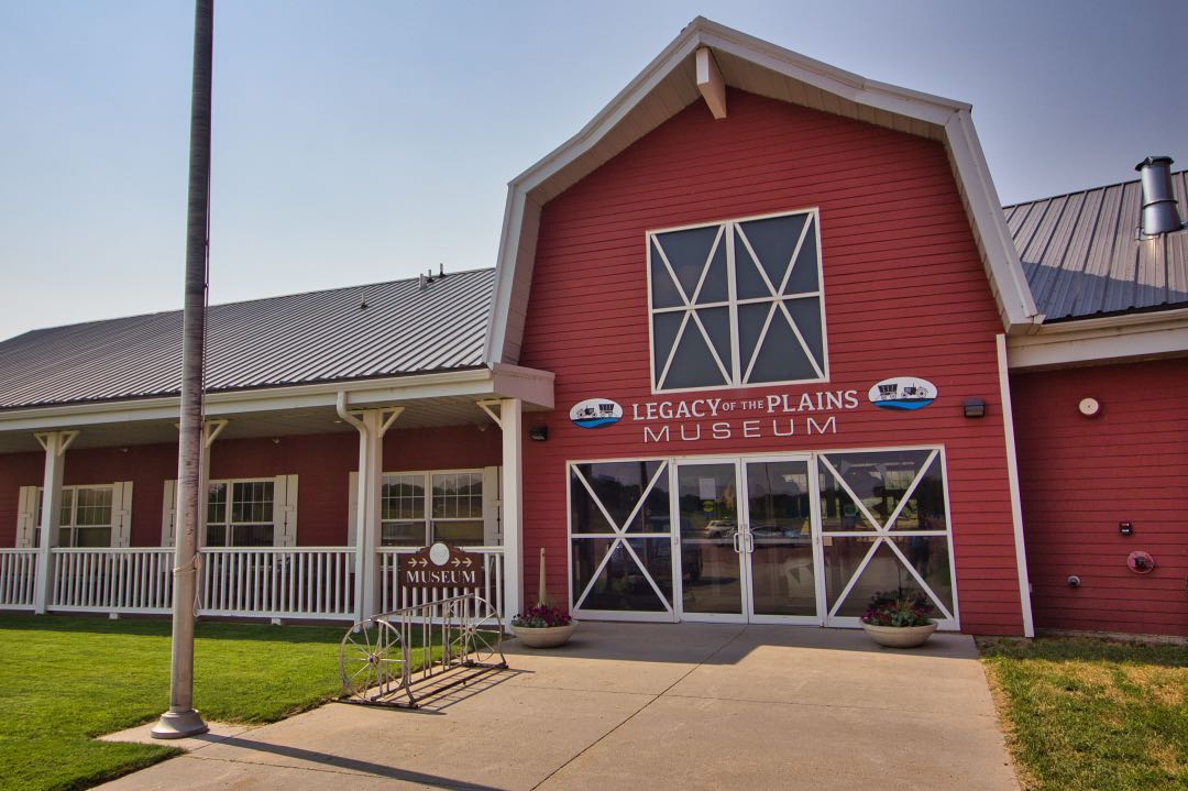 Red barn-style building with signs saying "Legacy of the Plains Museum".