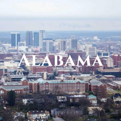 "Alabama" written across an aerial photo of a city, featuring many red buildings.
