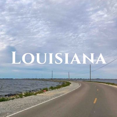 "Louisiana" written across a photo of a two-lane road stretching through water of the same height.