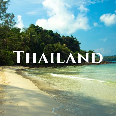"Thailand" written across a photo looking down a sandy beach toward thick palm trees.