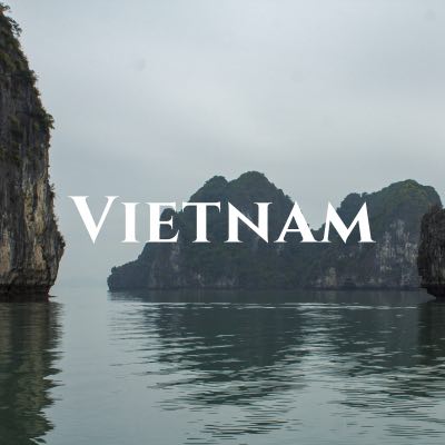 "Vietnam" written across a photo of karst mountains rising out of the water.